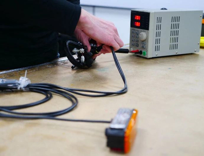 A member of Brucom staff test a light termination in our testing department