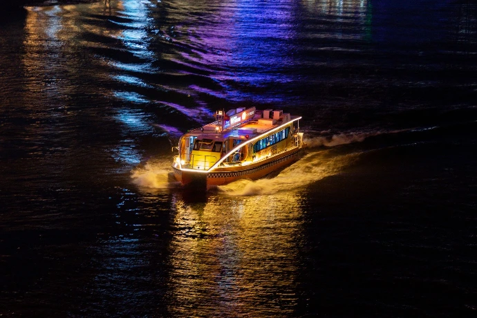 Taxi boat crossing water in the dark