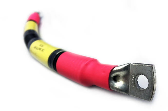 Automotive battery cable with connected terminal and heatshrink