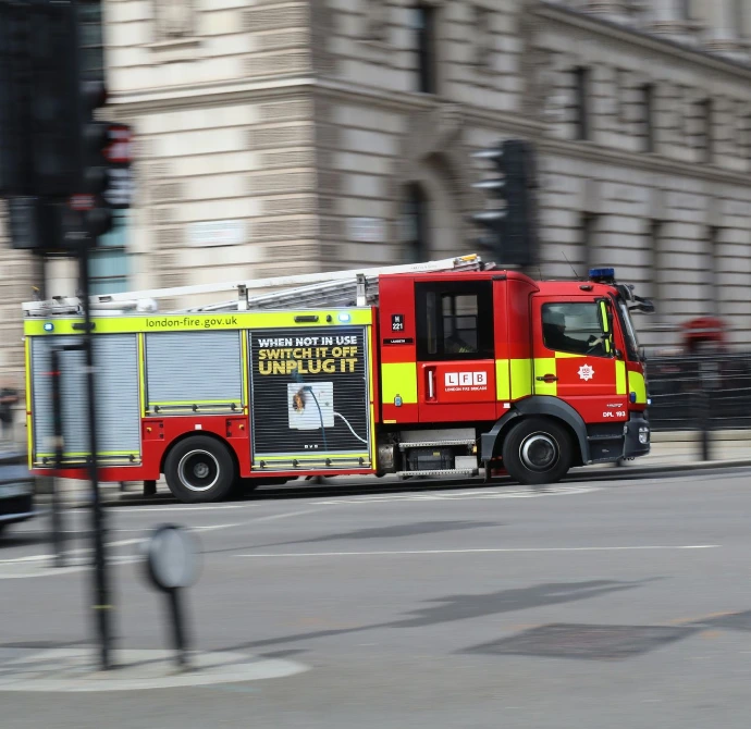 Fire engine driving through streets of London, sirens not on