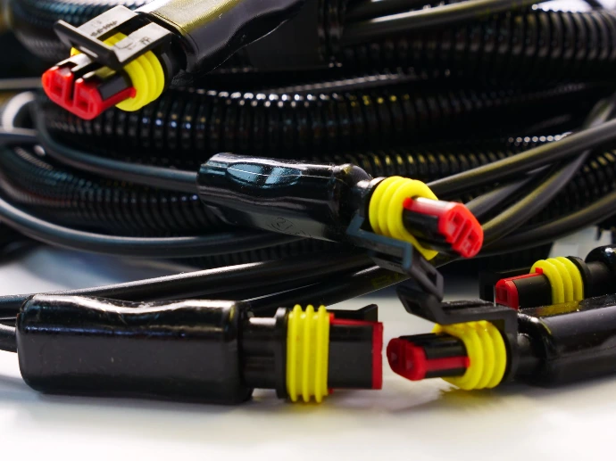 Overmoulded connectors at the end of a body loom