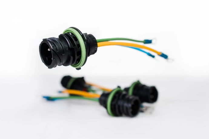 A simple cable assembly: a din connector with three wires attached, each ending in a metal terminal.
